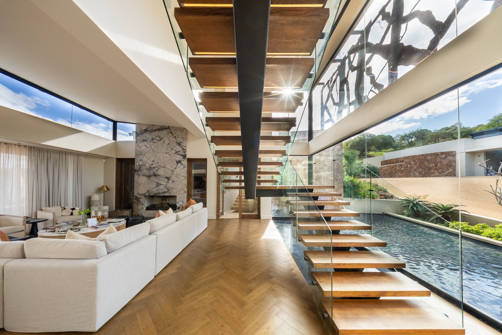 Floating timber staircase beside the glass line