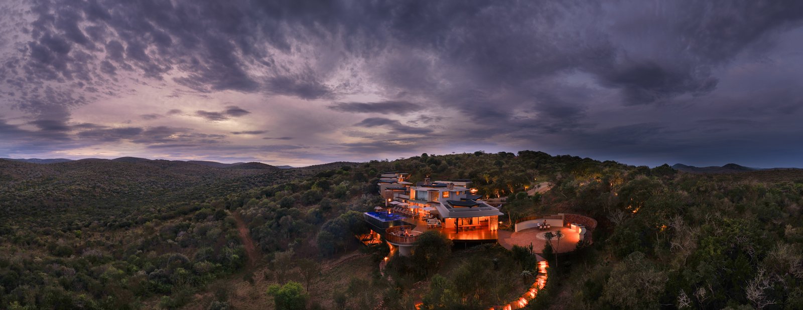Villa Thandawena lit at dusk within the Thanda Safari reserve