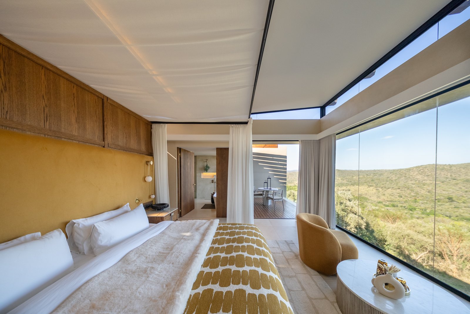 Canopied bedroom suite open to the bushveld