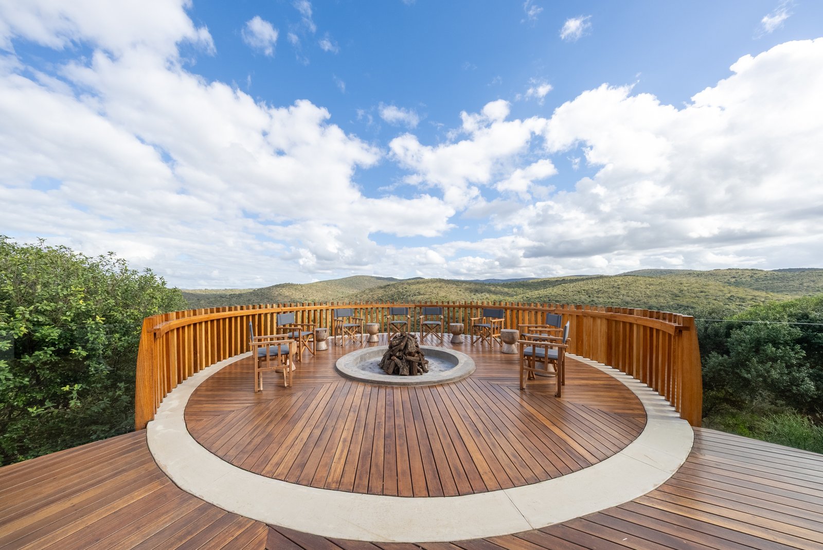 Circular firepit deck at the pool's edge